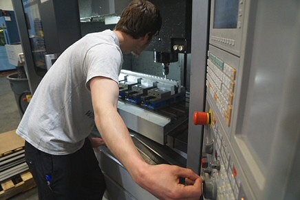 photo of machinist operating milling machine