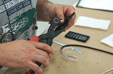 photo of man holding punching tool